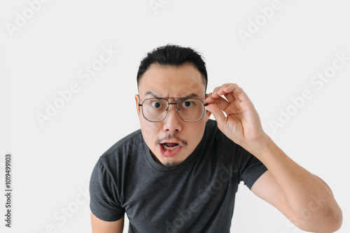 Serious angry face Asian freelance man bun hair in black on white.