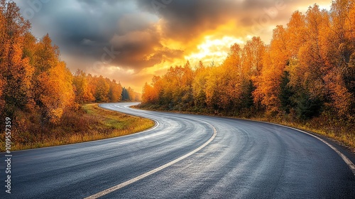 Curved road through vibrant autumn foliage at sunset