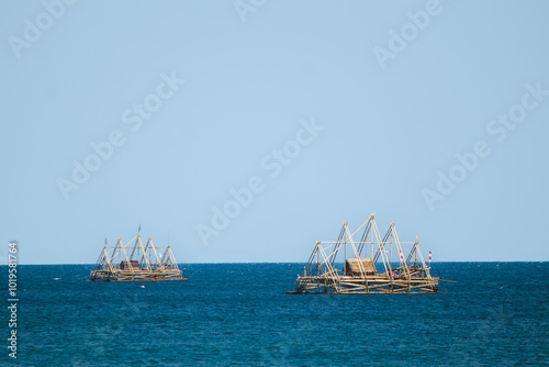 Fishing Bagan Floating on Calm Blue Waters.Refreshing Blue Waters on a Hot Summer’s Day. Traditional fish aggregating device, bamboo fish trap. photo