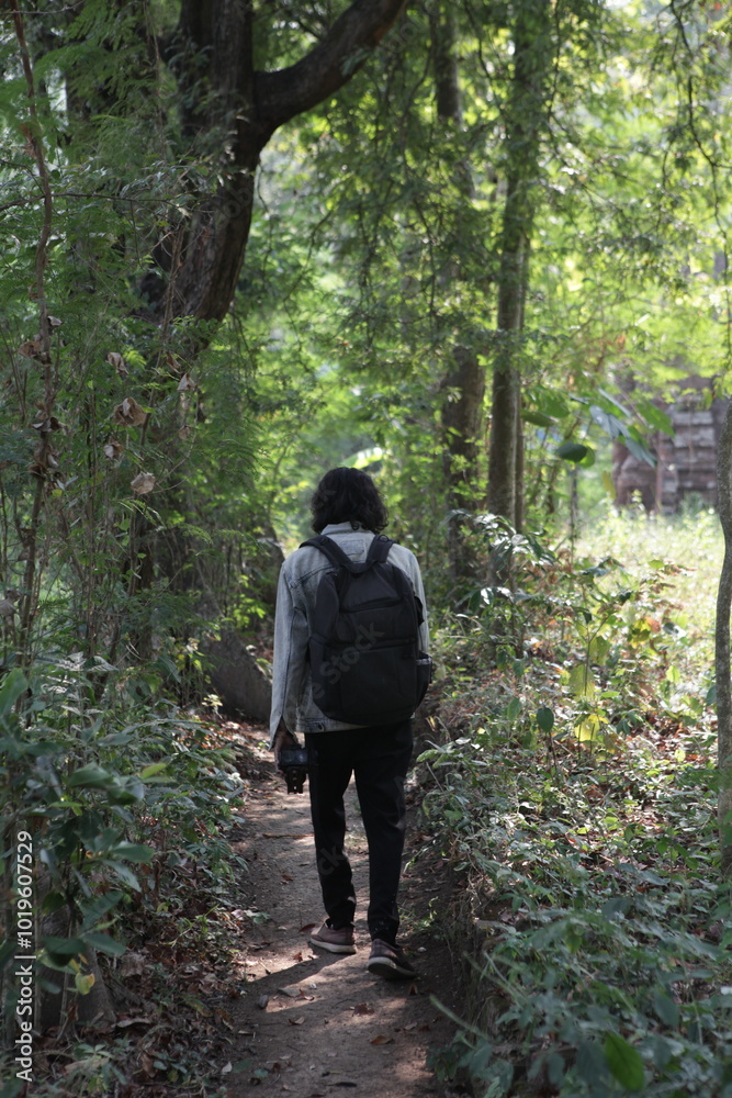 Fototapeta premium man walking in the forest