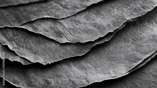 Textured Black Paper Sheets Layered in Abstract Pattern