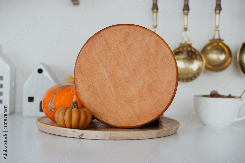 Rustic kitchen display featuring a wooden cake stand and decorative pumpkins in autumn Rustic kitchen display featuring a wooden cake stand and decorative pumpkins in autumn