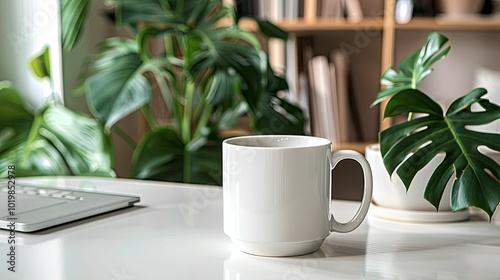 White Coffee Mug on a White Table with Green Plants and a Laptop in the Background