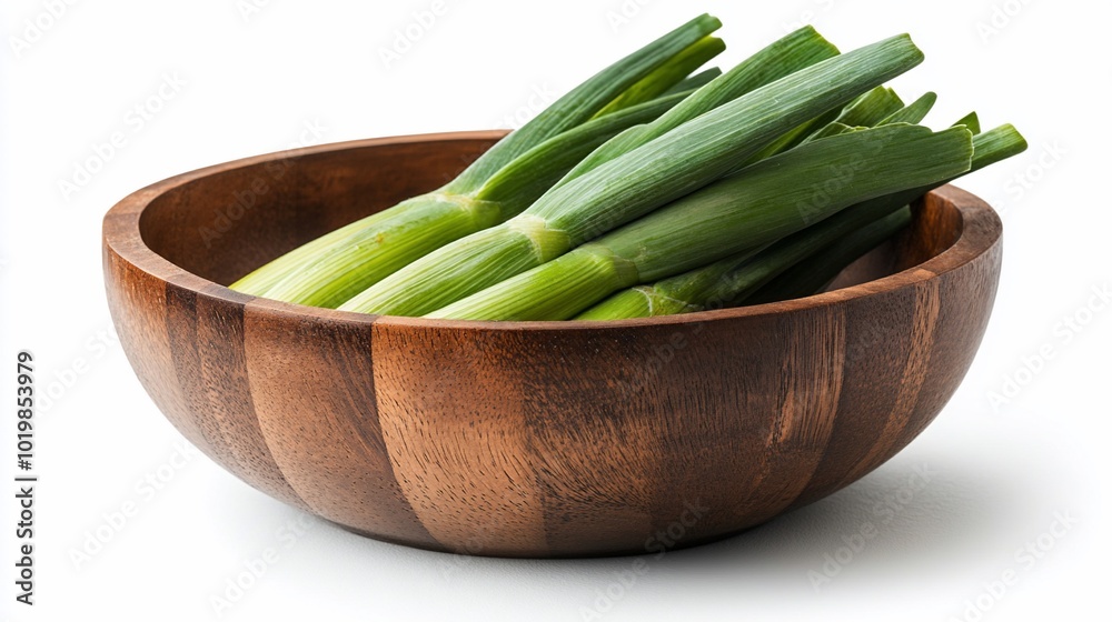 Fresh green scallions in a wooden bowl isolated on a white background. Fresh green scallions in a wooden bowl isolated on a white background.