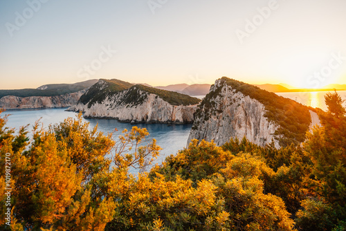 Lighthouse on the cliff. Seascape of Cape Lefkatas with old lighthouse on Lefkada island, Greece. Beautiful views of azure sea water and nature with cliffs photo