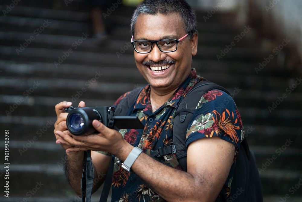 An Happy Indian photographer looking at camera An Happy Indian photographer looking at camera