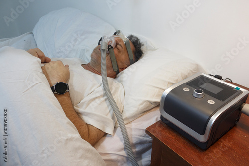 Man Sleeping with CPAP Machine for Sleep Apnea