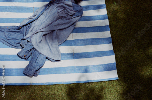 Denim jacket untidy strewing on the blue mat