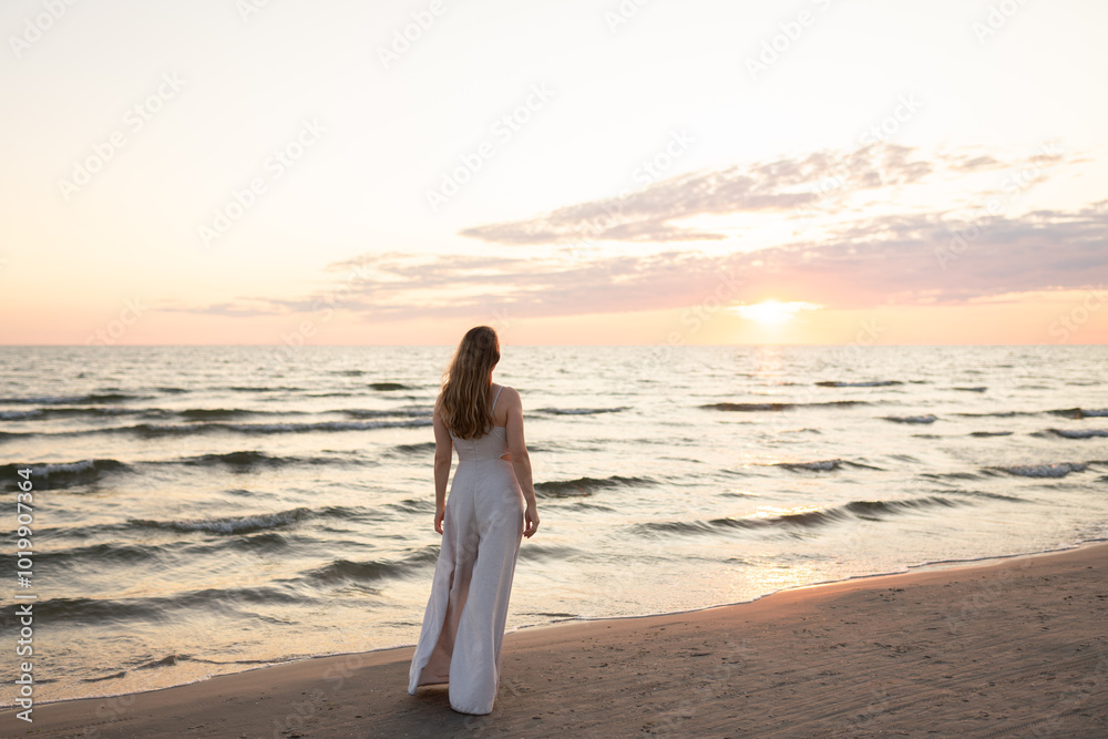 Anonymous woman enjoying sunset view in the beach Anonymous woman enjoying sunset view in the beach