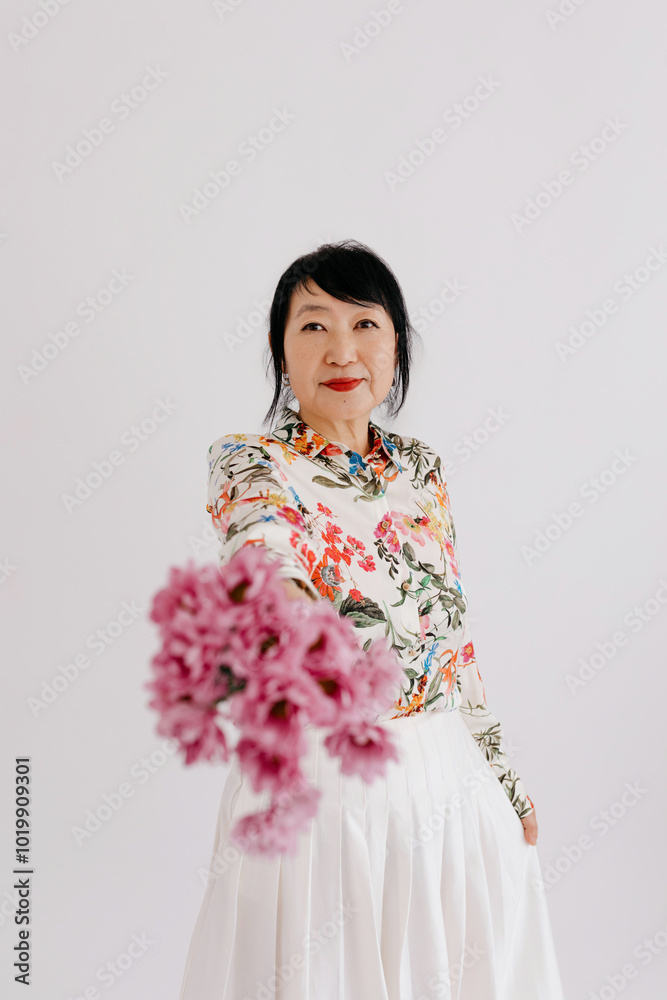 Charming mature woman in stylish clothes in studio