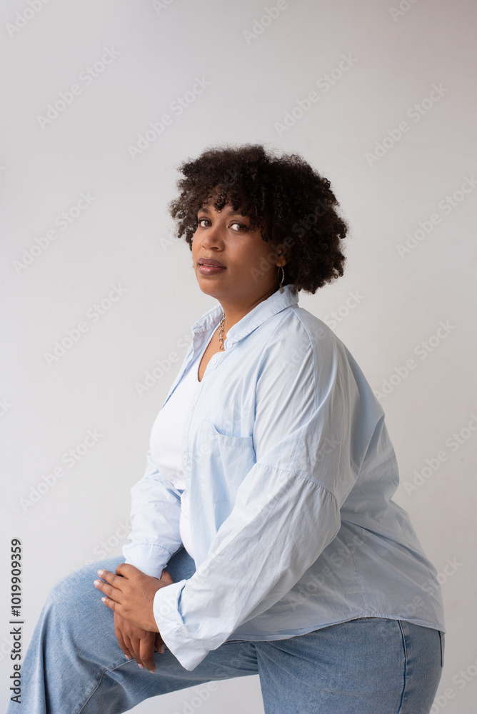Woman Poses Gracefully Against a Plain Background Woman Poses Gracefully Against a Plain Background