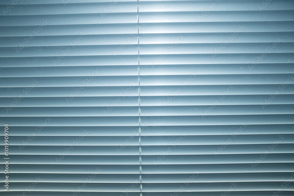 View of window with silver metallic blinds with hard direct flashlight View of window with silver metallic blinds with hard direct flashlight
