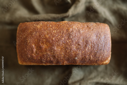 Whole loaf of artisanal bread with a golden brown crust photo