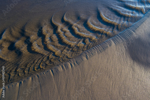 Tide pools and flowing water on beach