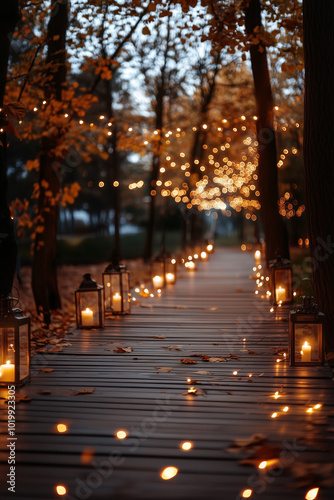 Cozy autumn pathway softly illuminated by glowing lanterns in forest.