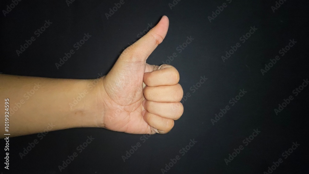 Hand thumb up isolated on black background Hand thumb up isolated on black background