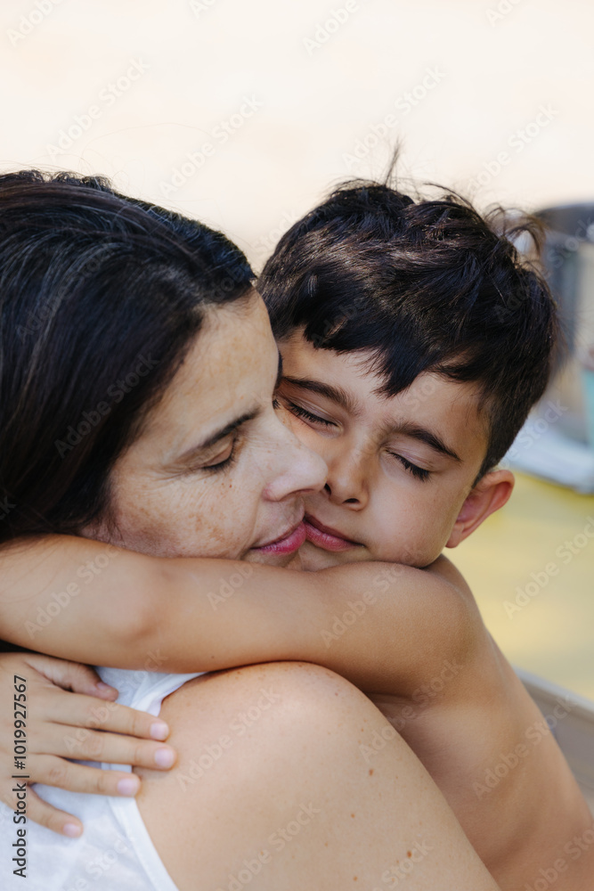 Mother and son hugging tightly, sharing a tender and heartfelt moment Mother and son hugging tightly, sharing a tender and heartfelt moment