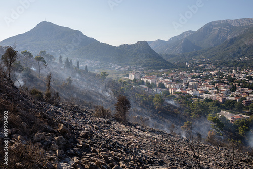 Aftermath of a forest fire on a hill above the town photo