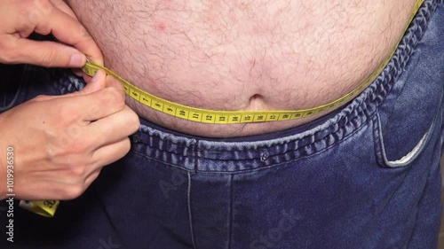 fat overweight man with big belly paunch measure waist circumference
