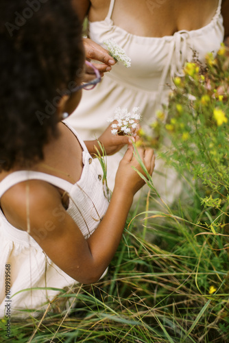 happy black mother and daughter outside in summer photo