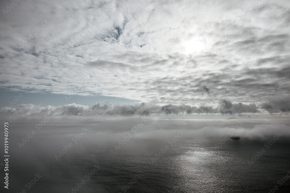 Cloudy sky and calm ocean with gentle sunlight reflection Cloudy sky and calm ocean with gentle sunlight reflection