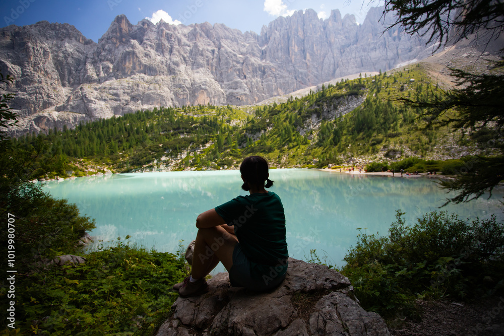 Fototapeta premium Travel woman man hiker at Sorapis Lake in the Dolomite Mountains