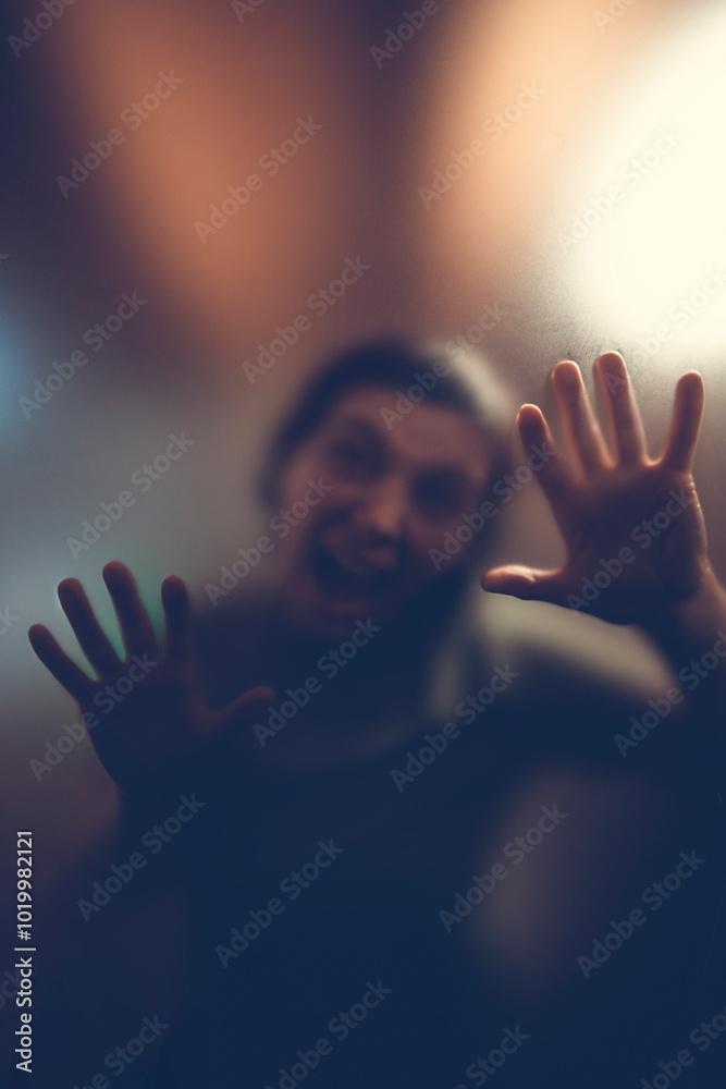 Scary picture of hands behind glass, horror ghost behind door, Halloween concept