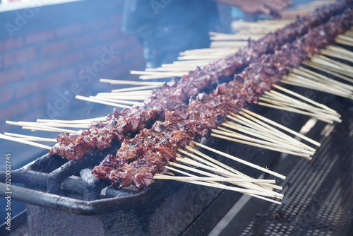 Sate or satay Maranggi is made from beef and served with sambal kecap (red chili and soy sauce). The meat is heavily marinated with spices and grilled until charred on both sides photo