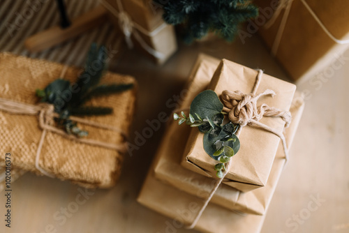 Sophisticated gift wrapping in kraft paper using natural elements such as pine twigs and eucalyptus. photo