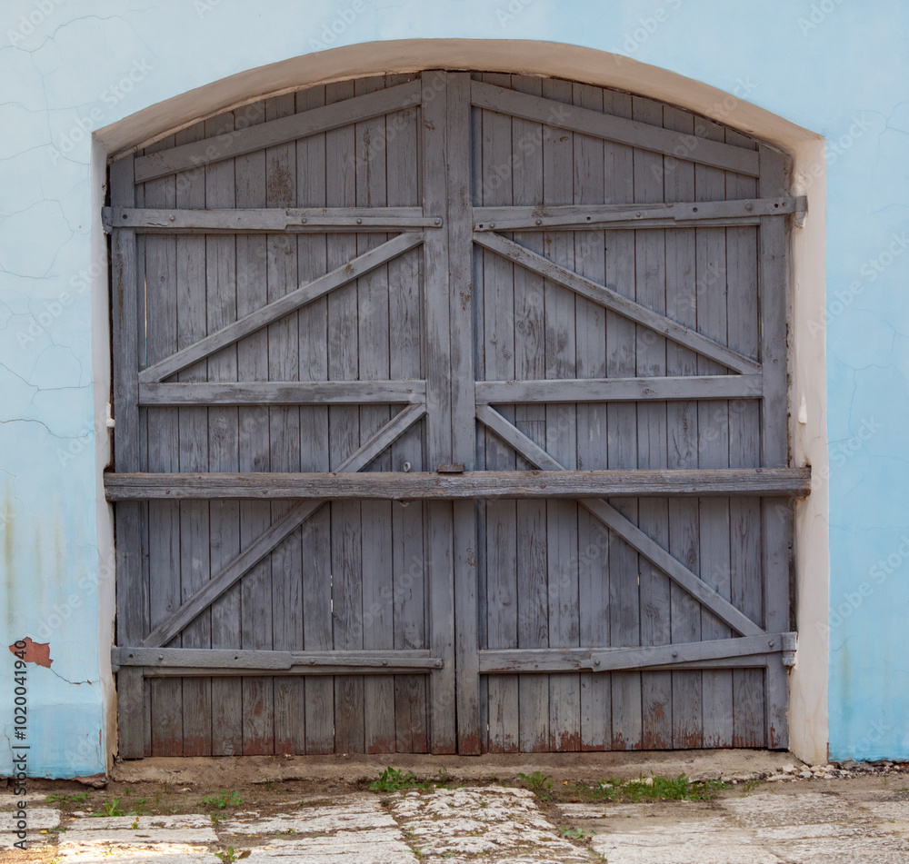 The garage door is made of wood and has a rustic look The garage door is made of wood and has a rustic look