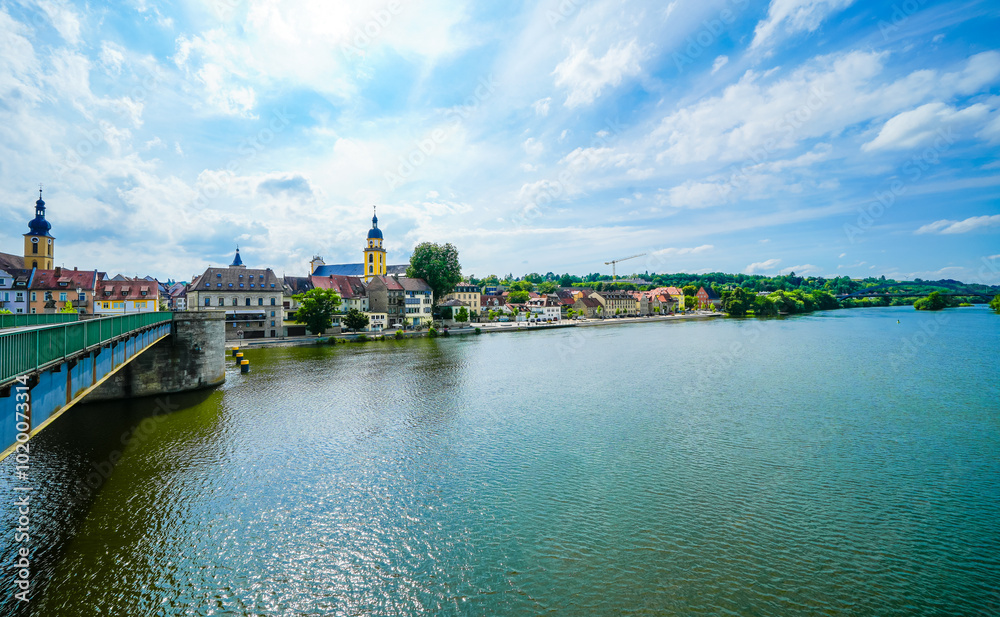 Naklejka premium View from the Old Main Bridge of the Main and the city of Kitzingen. Medieval stone bridge of the city.