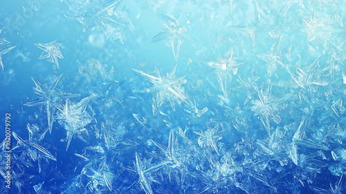 Close-up of delicate snowflakes on blue frosty background