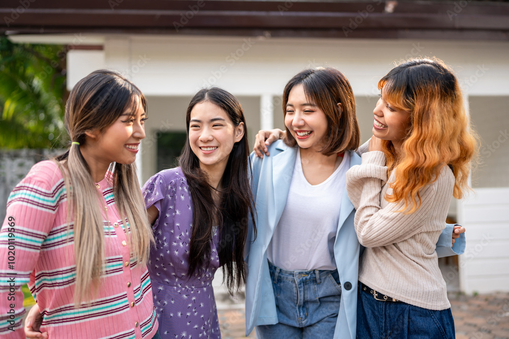 Group of women friends standing together outdoors in front of a house. Group of women friends standing together outdoors in front of a house.