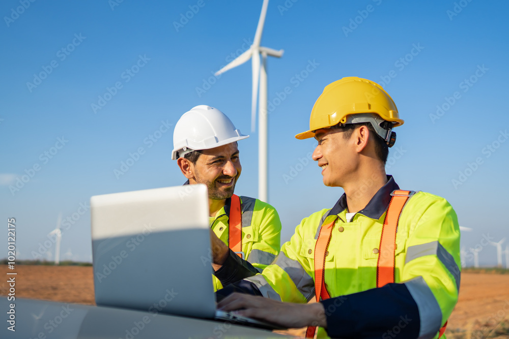 Diverse ethnicity male technicians working in the wind turbines field.