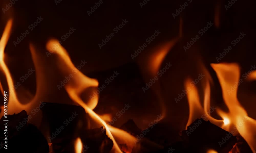 Fiery orange flames dance in mesmerizing display of heat. Fiery orange flames dance in mesmerizing display of heat.