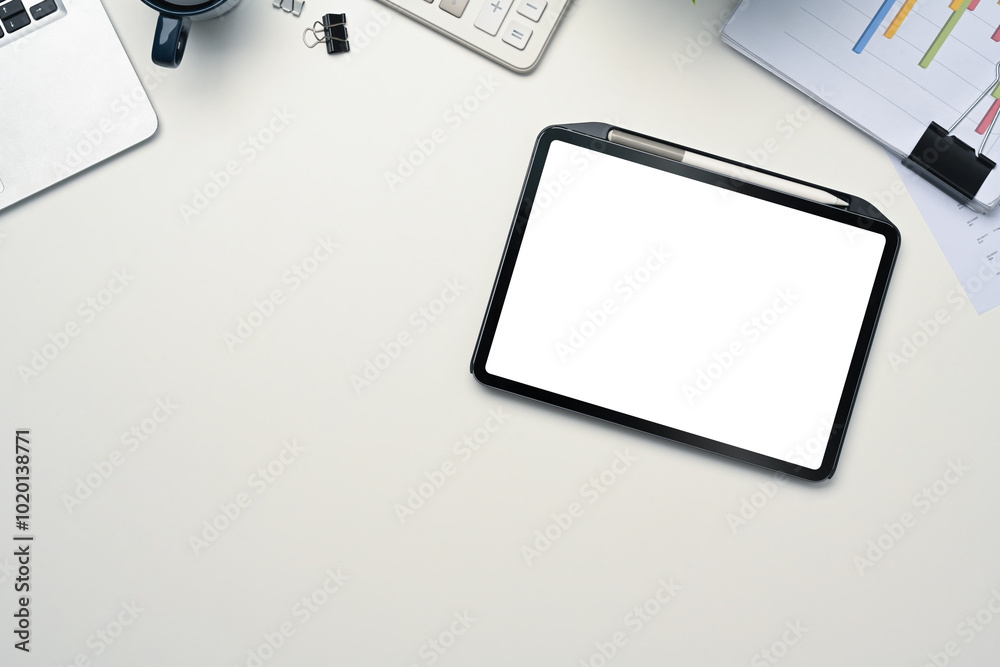 Digital tablet with empty display, laptop and financial document on white table Digital tablet with empty display, laptop and financial document on white table