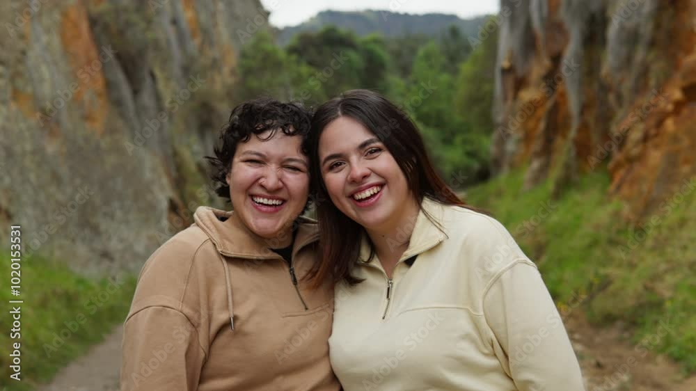 Two friends smile together in an outdoor setting at Las Rocas de Suesca, surrounded by rocky cliffs Two friends smile together in an outdoor setting at Las Rocas de Suesca, surrounded by rocky cliffs