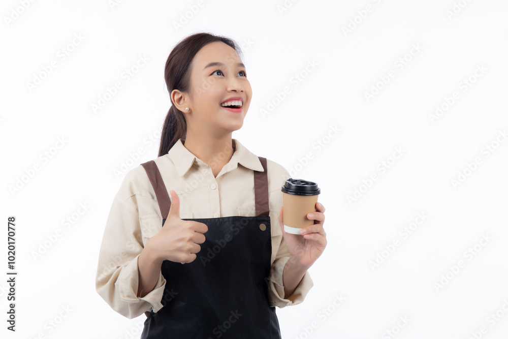 Cheerful young asian woman barista in casual work attire happily holding a takeaway coffee cup while thumbs up isolated white background, barista presenting takeaway coffee, small business or startup. Cheerful young asian woman barista in casual work attire happily holding a takeaway coffee cup while thumbs up isolated white background, barista presenting takeaway coffee, small business or startup.