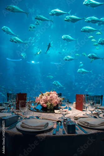 luxury color theme wedding solemnisation dinner flower florist , dinnerware banquet, cloth and stage lighting decoration design in premium hotel ballroom and beautiful beach event