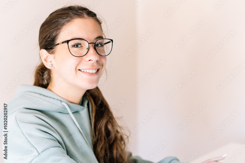 A lady wearing glasses and a green hoodie is smiling. A lady wearing glasses and a green hoodie is smiling.
