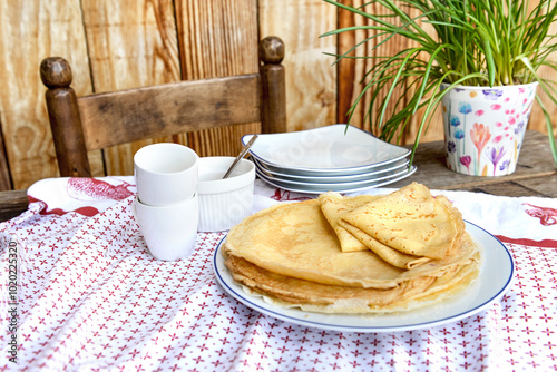 Canvas Print traditional french homemade pancakes in a plate served on a table with red and w