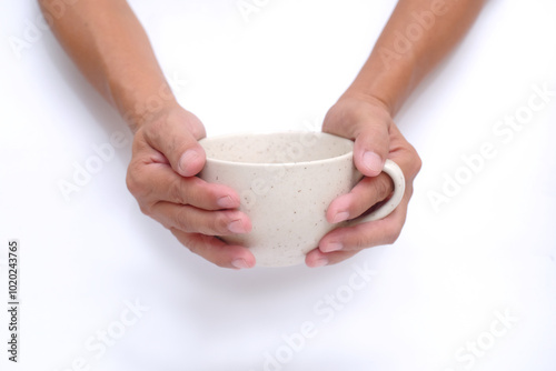 Close up: A man's hands are holding a ceramic mug photo