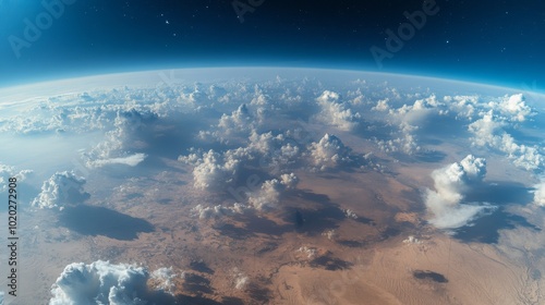 Earth's Atmosphere with White Clouds and a Desert Landscape Viewed from Space photo