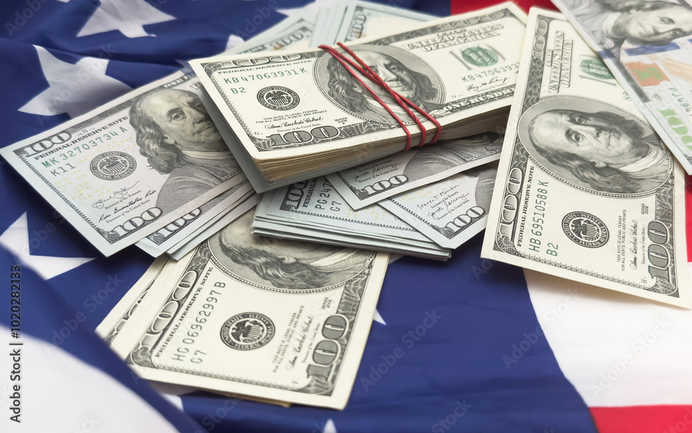 One hundred dollars banknotes on flag background One hundred dollars banknotes on flag background
