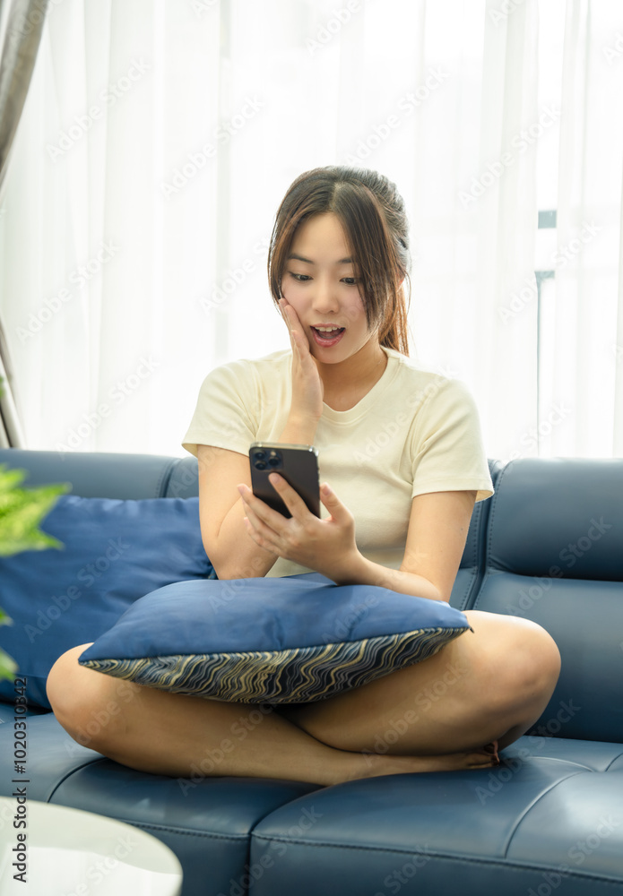 Image of young Asian girl using phone and relaxing at home Image of young Asian girl using phone and relaxing at home