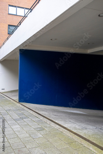 A minimalist architectural scene features clean lines and a striking blue accent wall, showcasing simplicity, modernism, and the interplay of color and form. photo