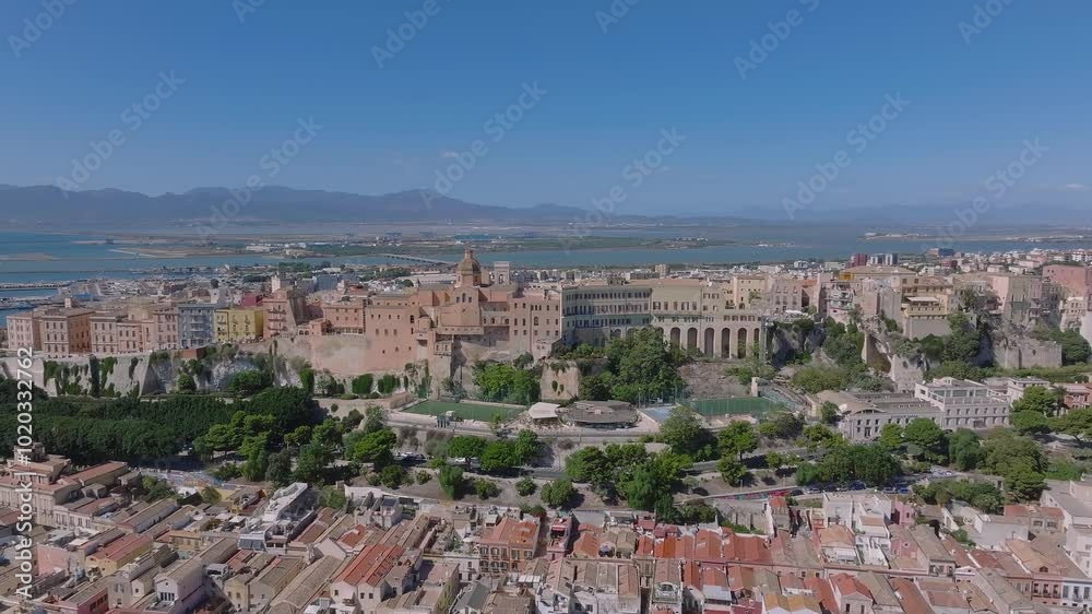 Cagliari's Castello district is seen from above, with medieval architecture, terracotta rooftops, and the Mediterranean Sea in the background. Cagliari's Castello district is seen from above, with medieval architecture, terracotta rooftops, and the Mediterranean Sea in the background.