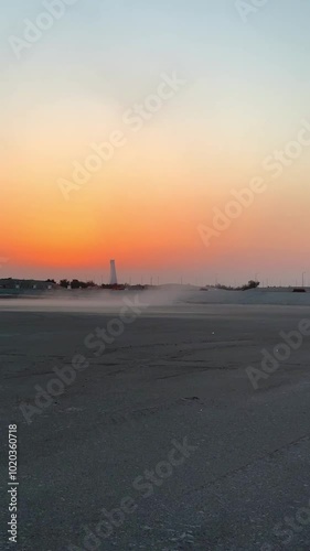 Whirlwind and dust devil in desert eroded ground are natural disasters caused by global warming and climate change. Global warming damages desert ecosystem. Desert phenomenon. Vertical video photo