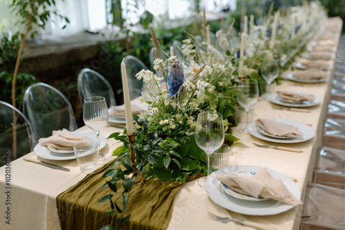 Modern stylish wedding table setting. The wedding decor. The pastel colors flowers bouquet. Natural beautiful wedding decorations. Minimalistic wedding decorations