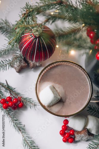 Hot chocolate in a glass with marshmallows on a background of bokeh lights, hot Christmas drink